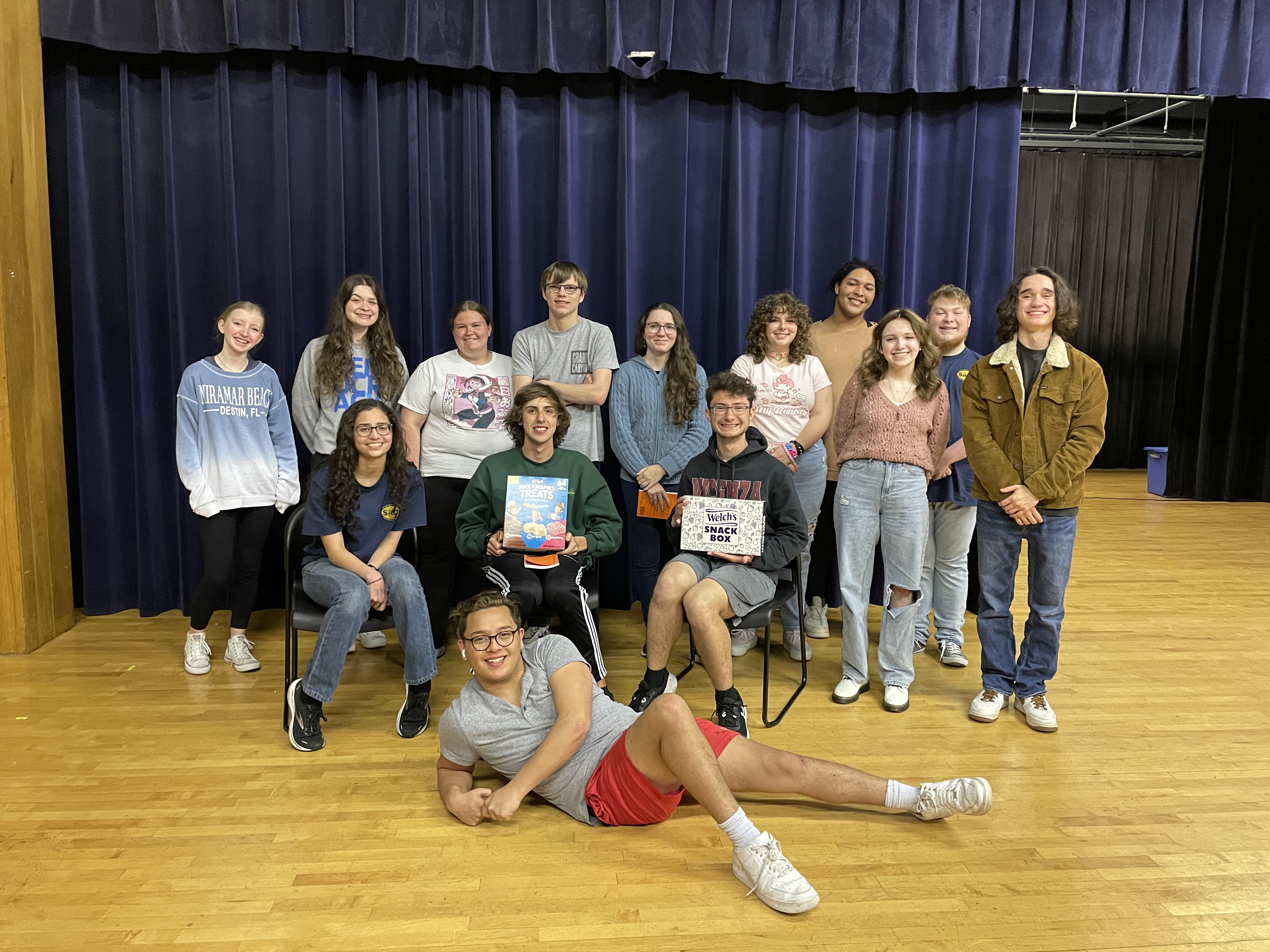 The cast and crew of "Our Town" poses with snacks donated by one of the district's amazing board members.