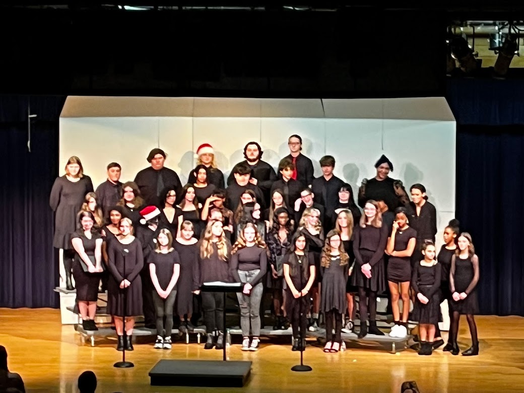 The choir enjoys applause after their winter concert.